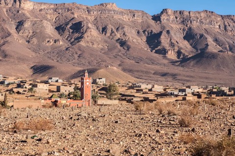 A semi deserted barbarian village in the atlas mountains surrounded by date palms along the road