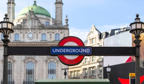 London Underground sign in front of a historic building on a sunny day, London, United Kingdom