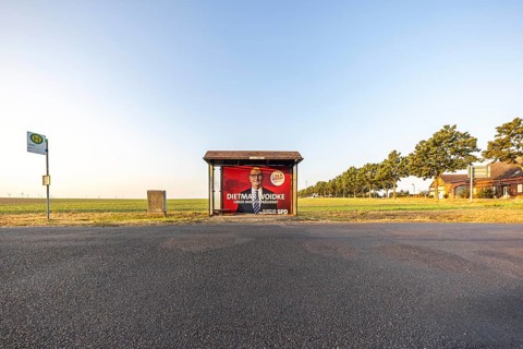State election in Brandenburg. Bus shelter in an open field with an election poster of Prime