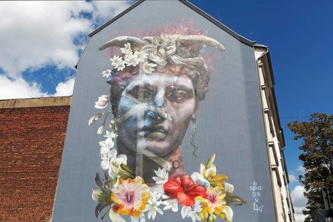 Portrait of a bigender person, bisexuality symbolised by horns and flower arrangement, mural by