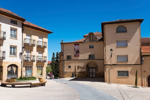 Sunny day in an old town with historic buildings, cobblestones and red roofs, Iglesia del Carmen,