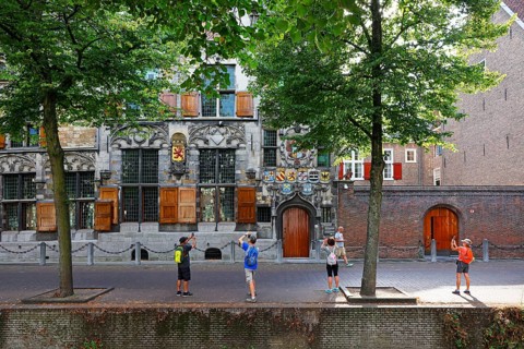 Historic city centre of Delft, tourists photograph Gemeenlandshuis van Delfland, town hall, oldest