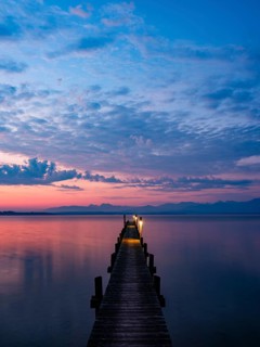 Footbridge on Lake Chiemsee at dawn, with the Chiemgau Alps behind, Chiemgau, Upper Bavaria,