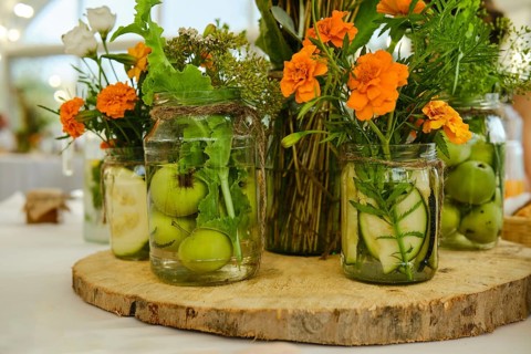 Concept of festive decoration of table, fruits and plants in jar with water