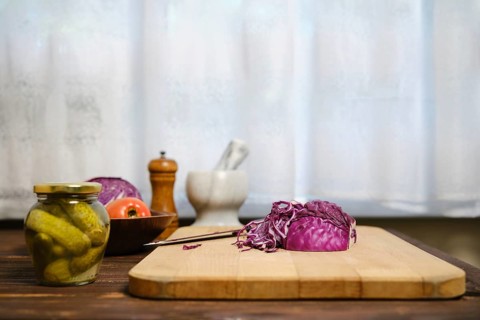 Red cabbage and ingredients for salad on kitchen table