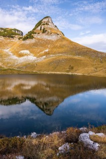 Lake Augstsee and the Atterkogel mountain on the Loser. Autumn, good weather, blue sky. Reflection.
