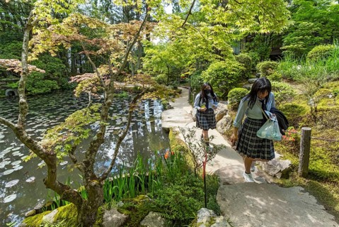 School girls stroll through Tenjuan Gardens, Nanzen-ji temple complex, Kyoto, Japan, Asia
