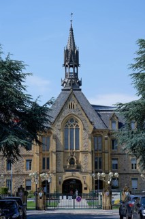 Historic building with Gothic tower and large windows, Fondation Jean-Pierre Pescatore,