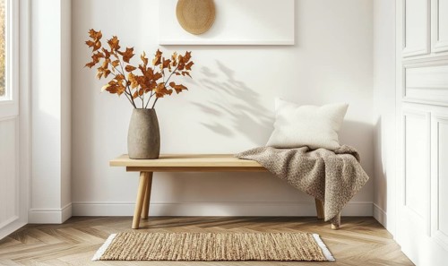 Scandinavian entryway with a light wooden bench, autumn leaves in a vase, a cozy throw blanket AI