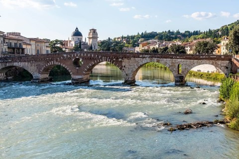 View of Verona historical city centre, Ponte Pietra bridge across Adige river, Verona Cathedral,