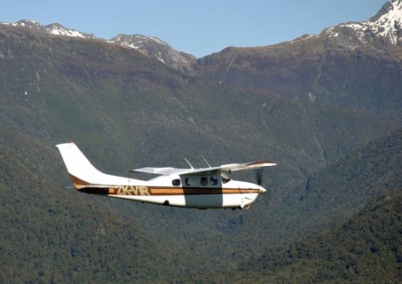 Single engined light aircraft flying over Westland, New Zealand, Oceania