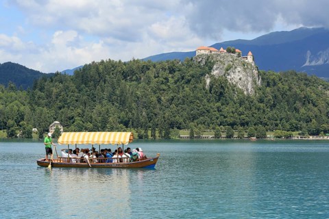 SLOVENIA, BLED, JULY 15, 2019: Traditional turist boat. Beautiful mountain lake in summer with