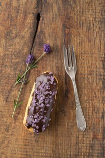 Eclair with chocolate ganache with candied lavender topping