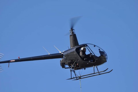 Helicopter lifts a load for a job in Westland, New Zealand, Oceania