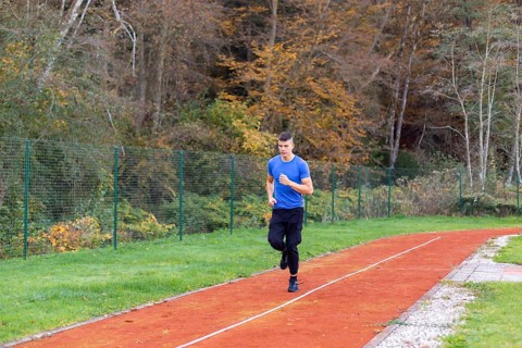 Young man jogging in the morning outdoor on the running race track
