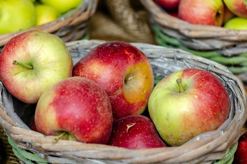 Market stall with orchard apples in a basket