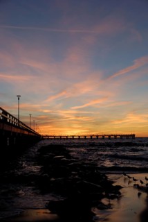 Sunset at the pier on the beach in Palanga, Lithuania, Europe