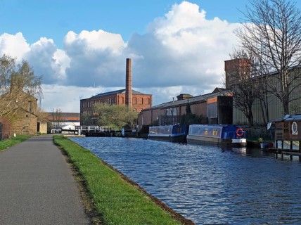 Oddy locks on the leeds to liverpool canal with the historic castleton mill in the background