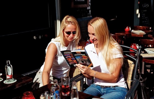 Two tourists reading a travel guide, Netherlands, Holland, Amsterdam
