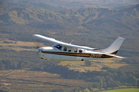 Single engined light aircraft flying over Westland, New Zealand, Oceania