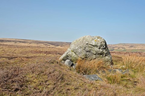 Pennine landscape with large old boulder or standing stone on midgley moor in west yorkshire