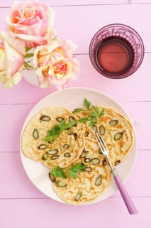 Pancakes with purple asparagus on a pink plate with roses