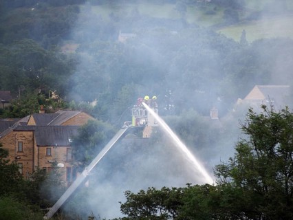 Hebden bridge, west yorkshire, united kingdom, 1 august 2019: firemen on an elevated platform
