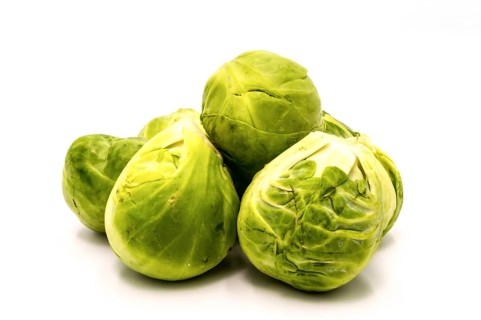 A pile of Brussels sprouts on a white background