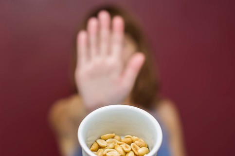 Great concept of food allergy, allergy to peanut, woman denying peanut