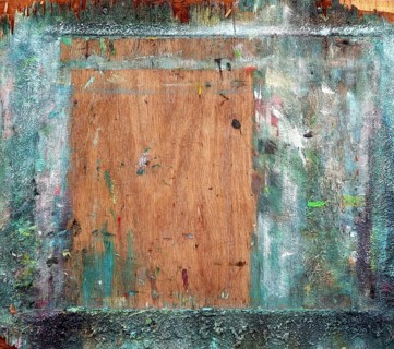 The backboard of an easel showing lots of use by a painter