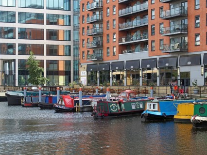 Leeds, west yorkshire, united kingdom, 16 july 2019: a view of of leeds dock houseboats and barges