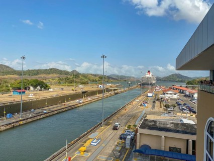 Cruise ship passing through a lock surrounded by industrial buildings, panama city, panamakanl,