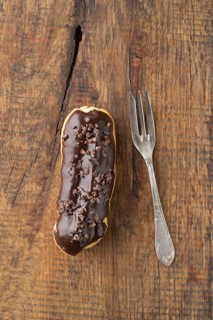Eclair with chocolate ganache with cocoa nibs topping