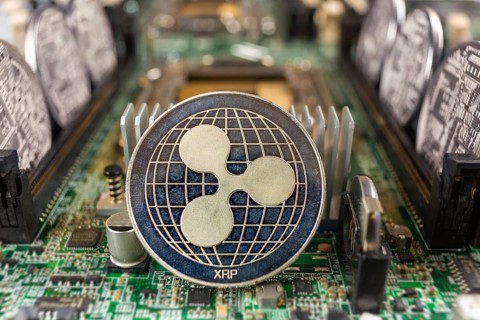 Ripple coin close-up on a computer circuit motherboard as a blockchain technology payment network.