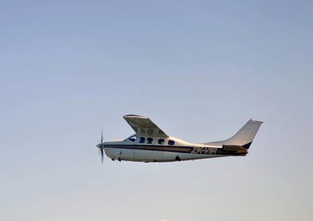 Single engined light aircraft flying over Westland, New Zealand, Oceania