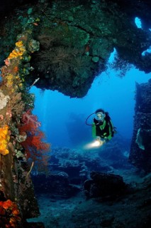 Two divers examine the Liberty shipwreck, Bali, Tulamben, Indian Ocean, Indonesia, Asia