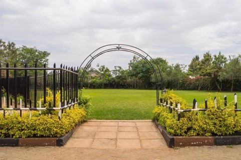 Entrance to a flower park with a barrier and an ark in the city of Nairobi Kenya