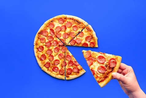 Woman's hand taking a slice of pizza, above view. Delicious pepperoni pizza isolated on a blue
