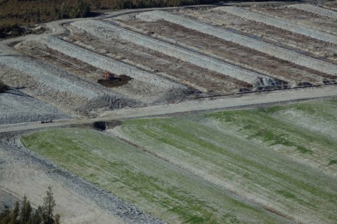 Diggers excavating land to make humps and hollows for farmland, West Coast, South Island, New