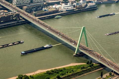 Ships on the Rhine pass under the Severin Bridge. Cargo ships, inland navigation