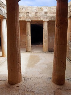 An underground chamber at the tombs of the kings in paphos cyprus with old eroded sandstone columns