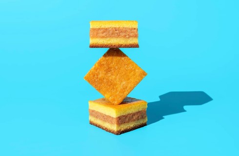 Homemade apple cake in bright light, minimalist on a blue table. Slices of apple cake in an