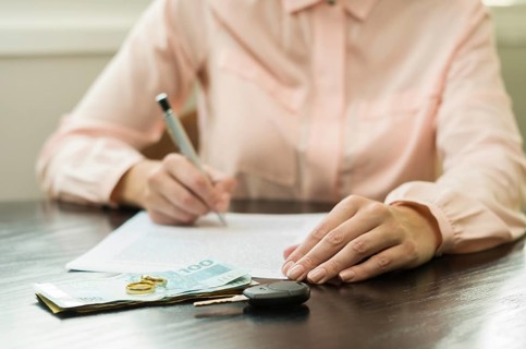 Great concept of divorce, end of relationship, young woman signing divorce agreement. Money, car