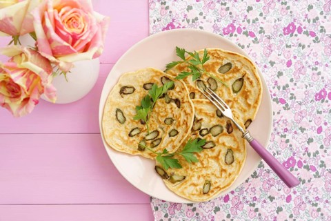 Pancakes with purple asparagus on a pink plate with roses