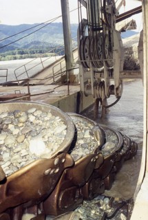 Bucket chain carries river bed gravel into the Ngahere Gold Dredge, West Coast, South Island, New