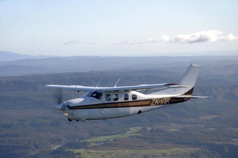 Single engined light aircraft flying over Westland, New Zealand, Oceania