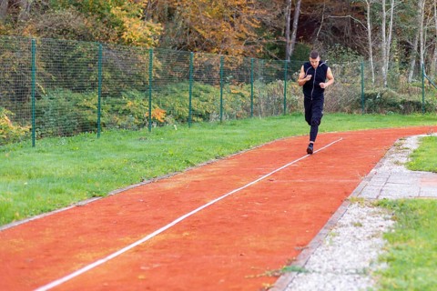 Young man jogging in the morning outdoor on the running race track