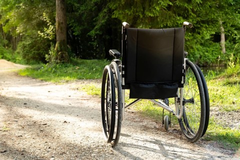 Photo of empty wheelchair parked in park, health care concept