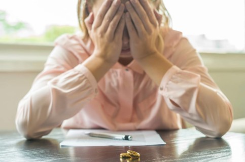 Great concept of divorce, end of relationship, sad young woman, signing divorce agreement, with