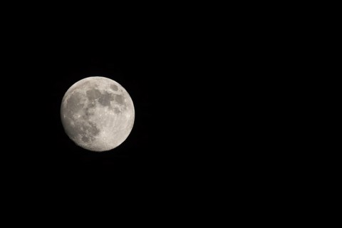 Waxing gibbous Moon, landscape orientated image with Moon isolated on black background with text or